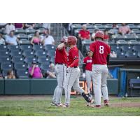 Scott Ota of the Sioux City Explorers celebrates with #8 Daniel Montano and Daniel Lingua following his three run home run