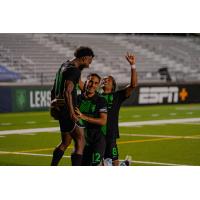 Lexington SC players Nico Brown (77), Jorge Corrales (12), and Yannick Yankam (8)