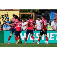 Atlético Ottawa celebrate Sam Salter's fourth goal of the season at Halifax last weekend