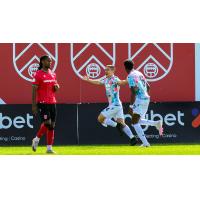 Midfielder Manny Aparicio celebrates opening the score for Atlético Ottawa