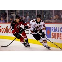 Vancouver Giants defenceman Colton Roberts (left) vs. the Calgary Hitmen